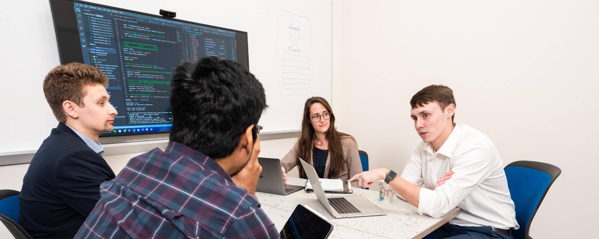 Developers collaborating in a meeting.